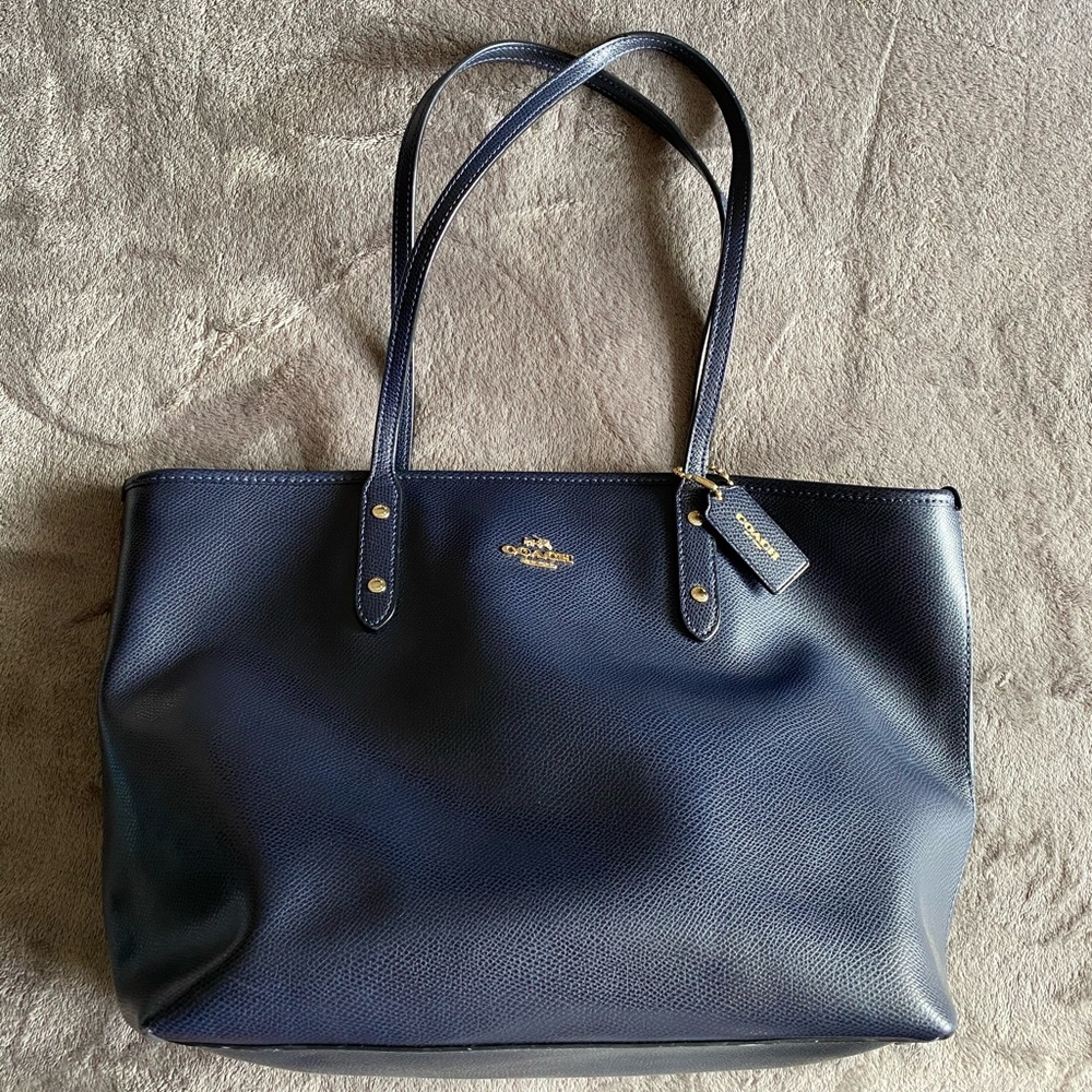 Used. Coach. Navy blue w gold trimming.